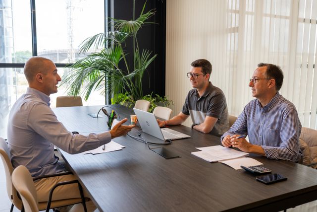 Professionals engaged in a collaborative business meeting at a modern office setting.